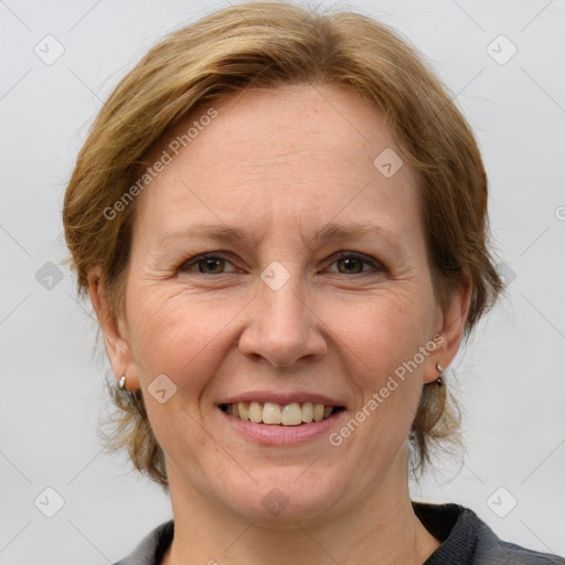 Joyful white adult female with medium  brown hair and grey eyes