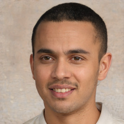 Joyful latino young-adult male with short  black hair and brown eyes