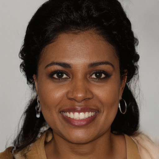 Joyful black young-adult female with medium  black hair and brown eyes
