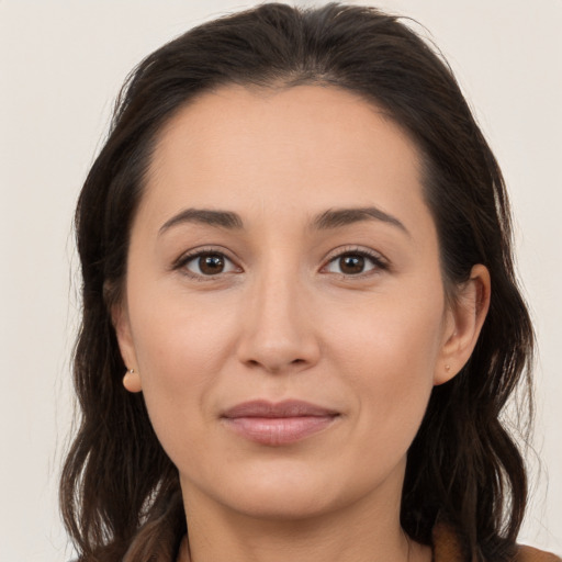 Joyful white young-adult female with long  brown hair and brown eyes