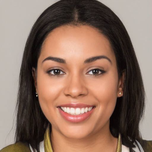 Joyful latino young-adult female with medium  brown hair and brown eyes