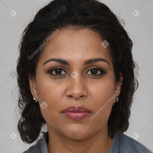 Joyful black adult female with long  brown hair and brown eyes