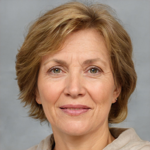 Joyful white middle-aged female with medium  brown hair and blue eyes