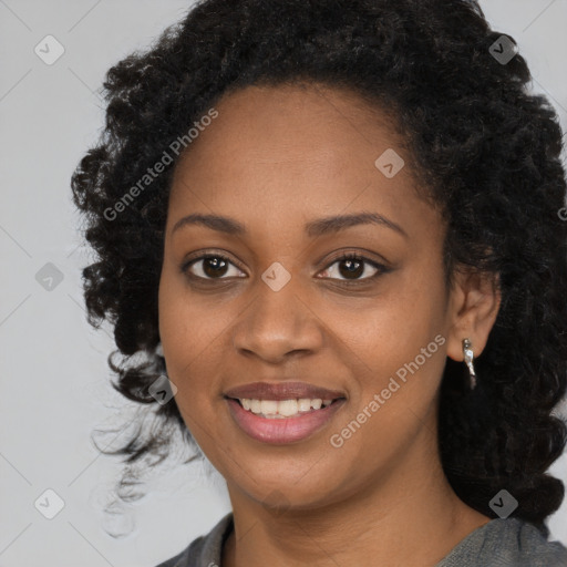 Joyful black young-adult female with long  black hair and brown eyes