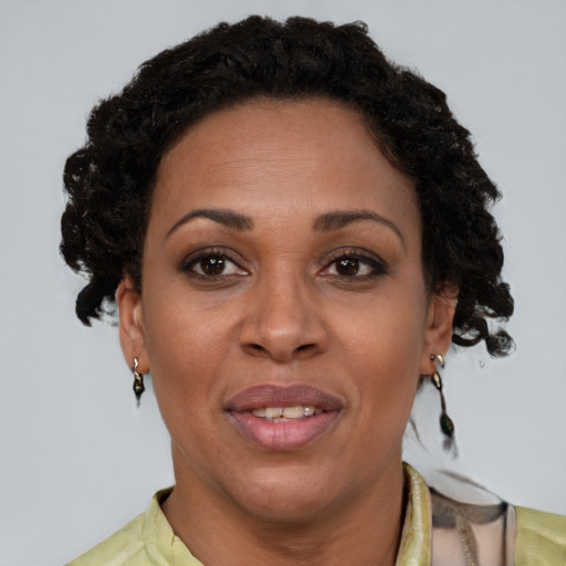 Joyful black adult female with short  brown hair and brown eyes