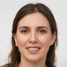 Joyful white young-adult female with long  brown hair and grey eyes