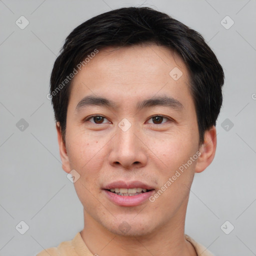 Joyful asian young-adult male with short  brown hair and brown eyes