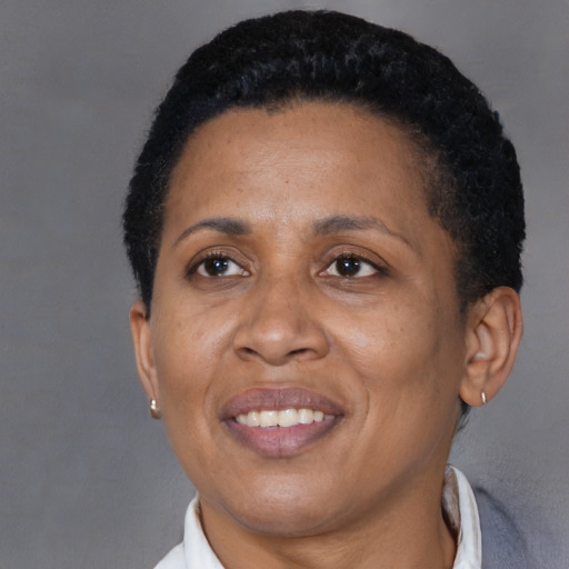 Joyful black adult female with short  black hair and brown eyes