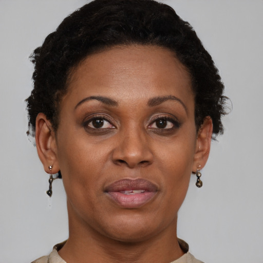 Joyful black adult female with short  brown hair and brown eyes