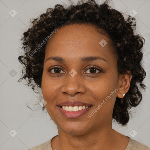 Joyful black young-adult female with medium  brown hair and brown eyes