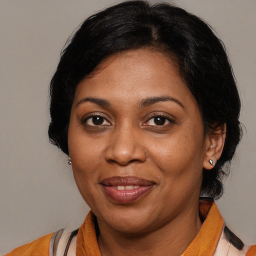 Joyful black young-adult female with medium  brown hair and brown eyes