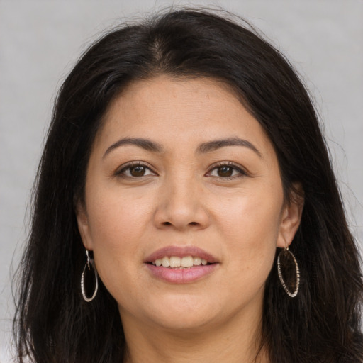 Joyful asian young-adult female with long  brown hair and brown eyes