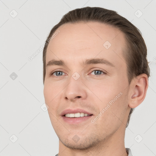 Joyful white young-adult male with short  brown hair and grey eyes