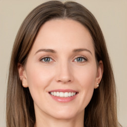 Joyful white young-adult female with long  brown hair and brown eyes