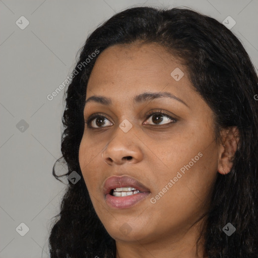 Joyful black young-adult female with long  black hair and brown eyes