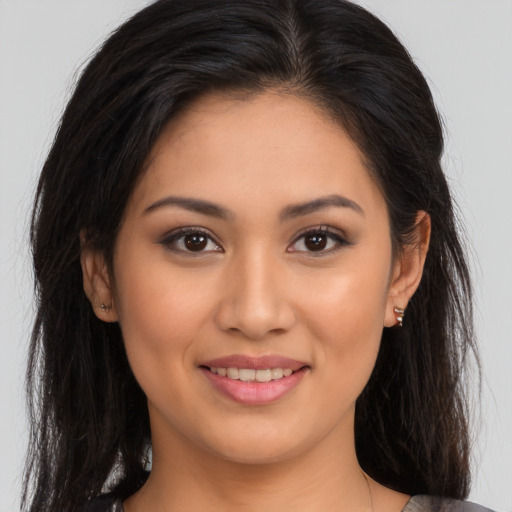Joyful white young-adult female with long  brown hair and brown eyes