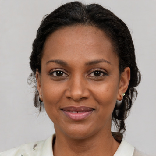 Joyful latino adult female with short  brown hair and brown eyes