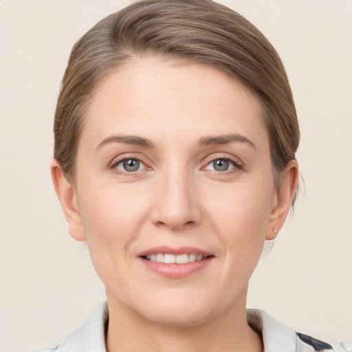 Joyful white young-adult female with short  brown hair and grey eyes