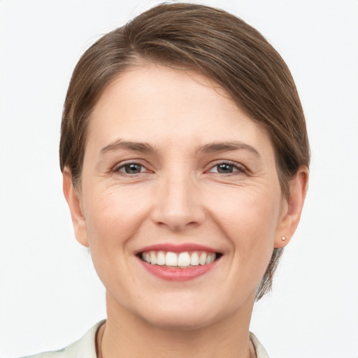 Joyful white young-adult female with short  brown hair and grey eyes