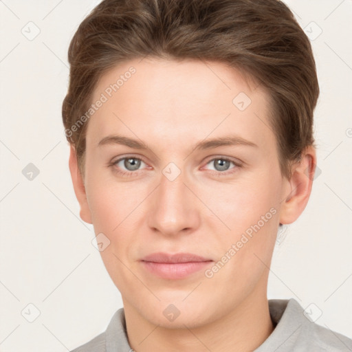 Joyful white young-adult female with short  brown hair and grey eyes