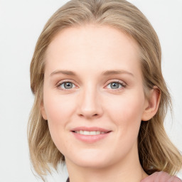 Joyful white young-adult female with medium  brown hair and blue eyes