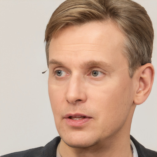 Joyful white adult male with short  brown hair and grey eyes