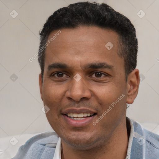 Joyful latino adult male with short  black hair and brown eyes