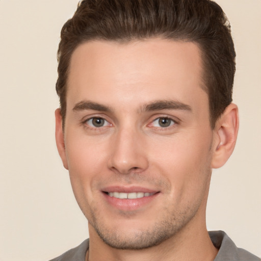 Joyful white young-adult male with short  brown hair and brown eyes