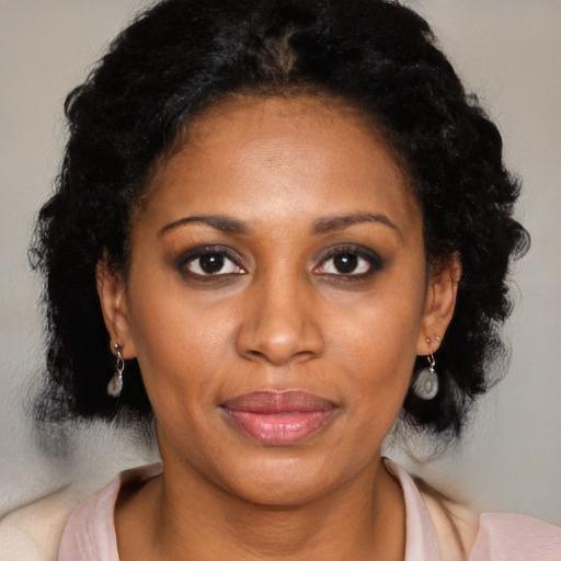 Joyful latino adult female with medium  black hair and brown eyes