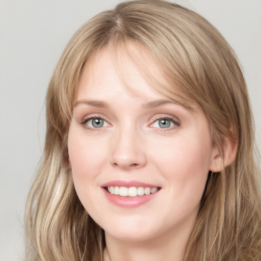 Joyful white young-adult female with long  brown hair and grey eyes