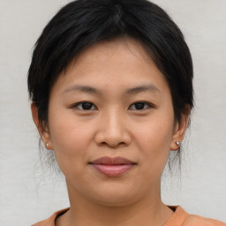 Joyful asian young-adult female with short  brown hair and brown eyes