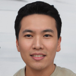 Joyful asian young-adult male with short  black hair and brown eyes