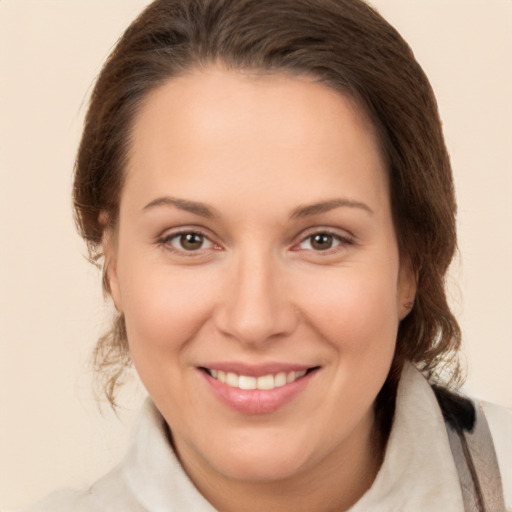 Joyful white young-adult female with medium  brown hair and brown eyes