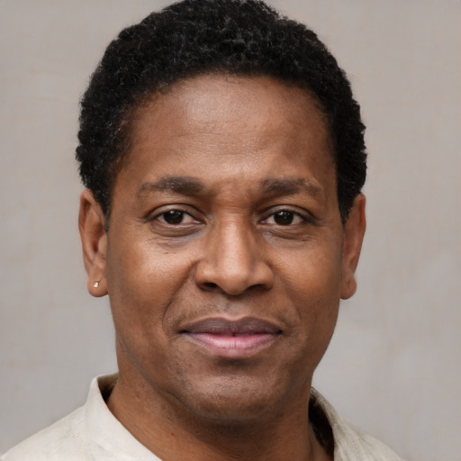 Joyful latino adult male with short  black hair and brown eyes