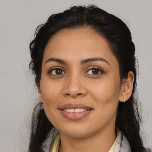 Joyful latino young-adult female with medium  brown hair and brown eyes