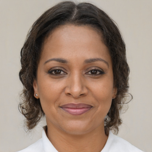 Joyful black young-adult female with medium  brown hair and brown eyes