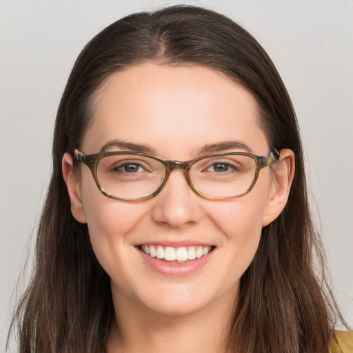 Joyful white young-adult female with long  brown hair and brown eyes