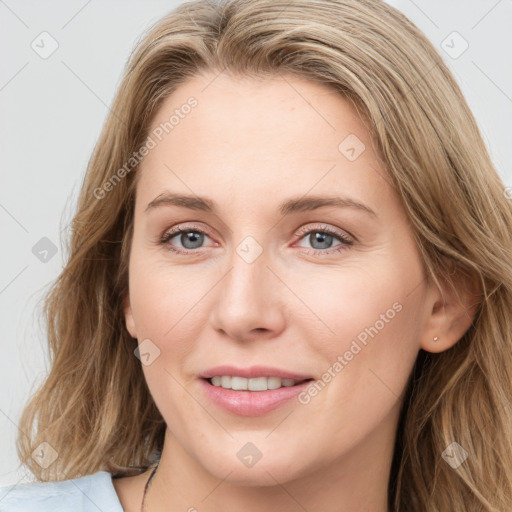 Joyful white young-adult female with long  brown hair and blue eyes