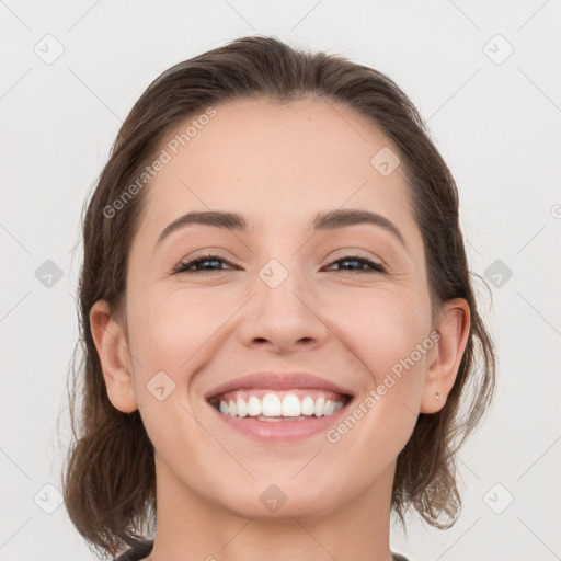 Joyful white young-adult female with medium  brown hair and grey eyes