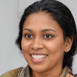 Joyful latino young-adult female with medium  brown hair and brown eyes