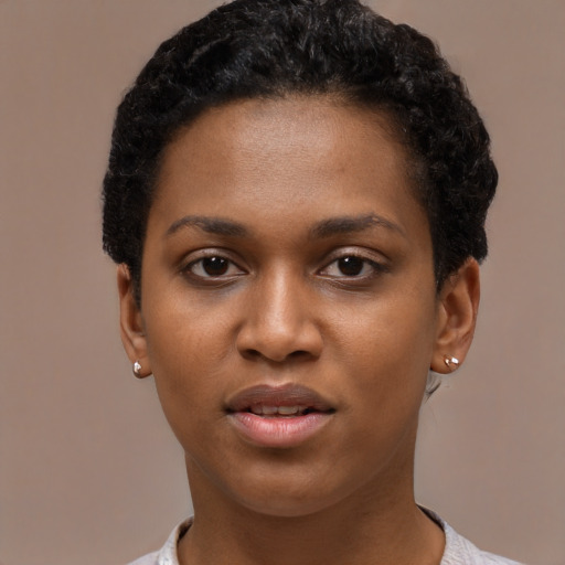 Joyful latino young-adult female with short  black hair and brown eyes
