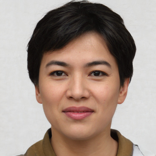 Joyful asian young-adult female with short  black hair and brown eyes