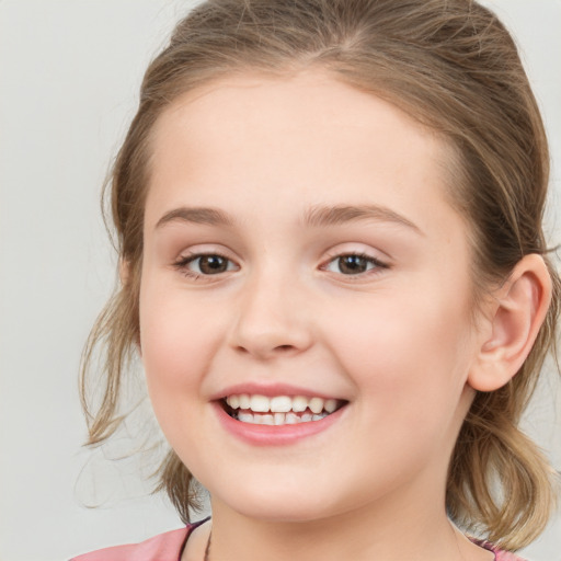 Joyful white child female with medium  brown hair and brown eyes