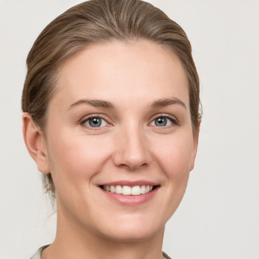 Joyful white young-adult female with short  brown hair and grey eyes