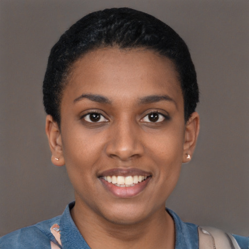 Joyful black young-adult female with short  black hair and brown eyes