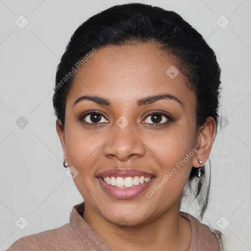 Joyful black young-adult female with short  black hair and brown eyes