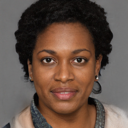 Joyful black adult female with short  black hair and brown eyes