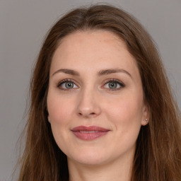 Joyful white young-adult female with long  brown hair and grey eyes