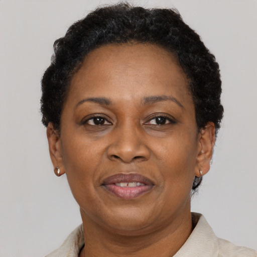 Joyful black adult female with short  brown hair and brown eyes