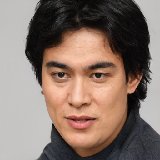 Joyful asian young-adult male with medium  brown hair and brown eyes